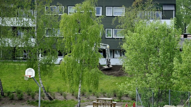 an apartment building with a basketball hoop in front of it